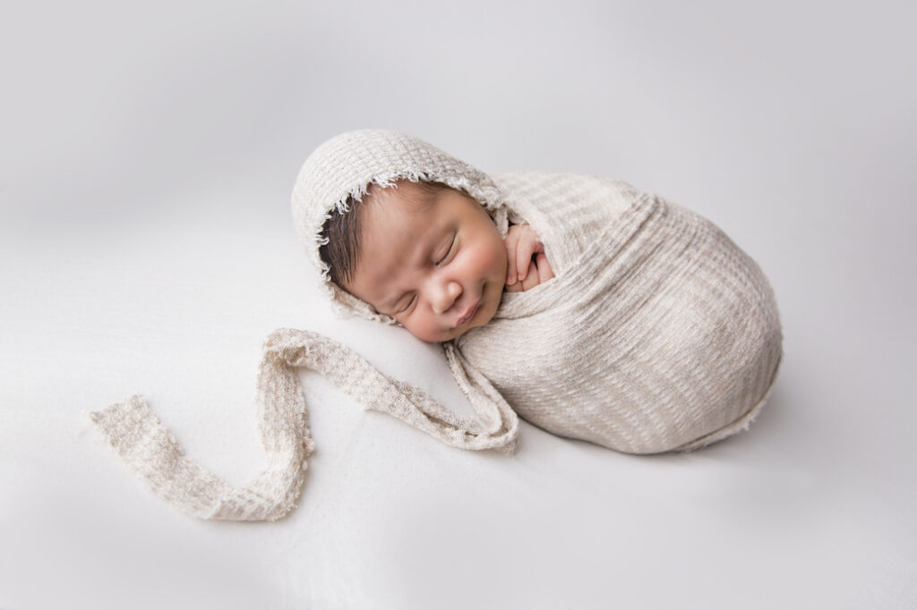 tweed nsw baby photographer baby wrapped in swaddle