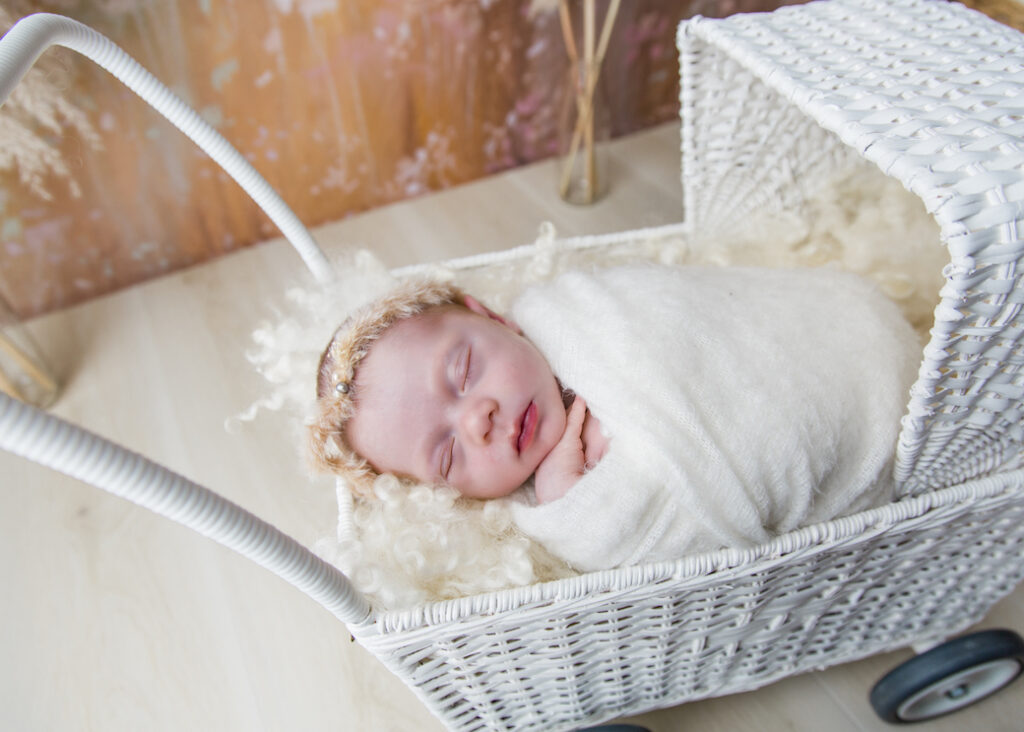 Baby in white cane pram photo Gold Coast QLD